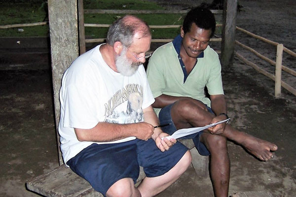 Lloyd Milligan working with Hobson, a Mangseng translator. Now Lloyd and Hobson use technology to communicate.